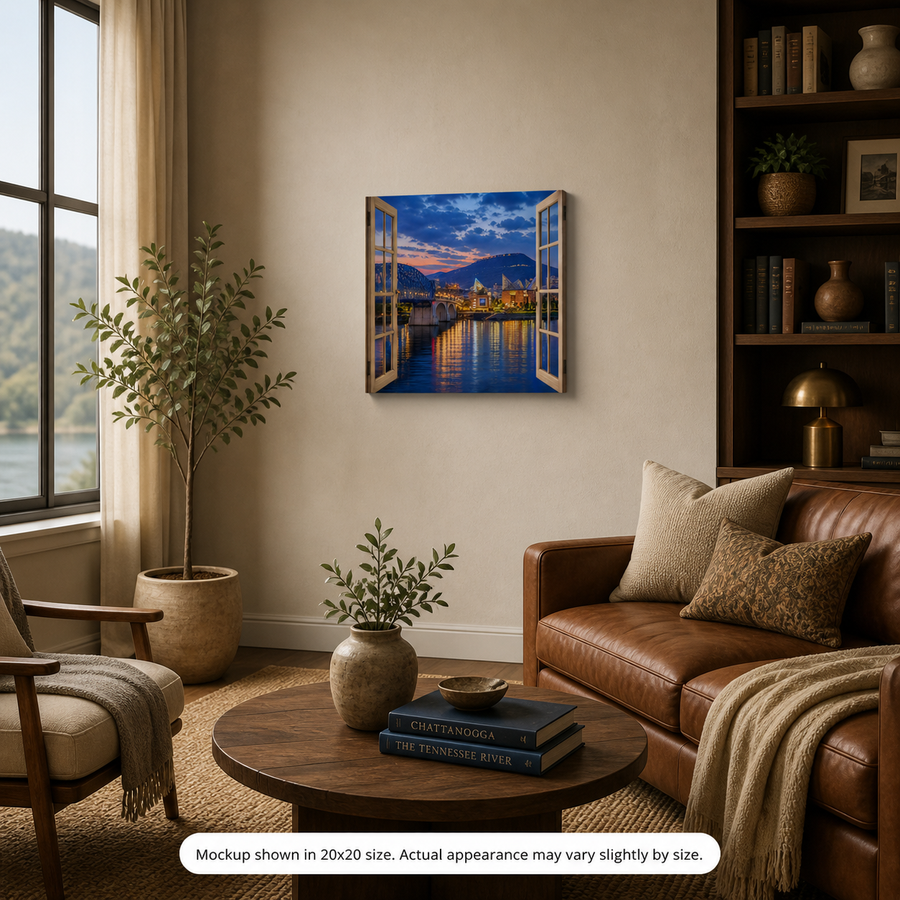 Scenic City canvas wall art displayed in a warm living room with leather seating, natural wood accents, books, plants, and a glowing riverfront city view
